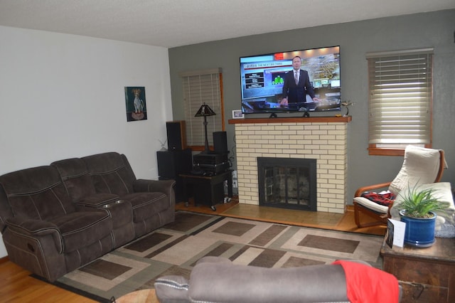 living area with a fireplace and wood finished floors