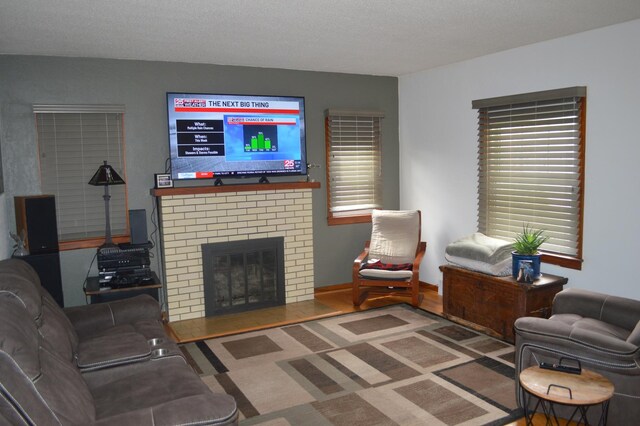 living room with a brick fireplace
