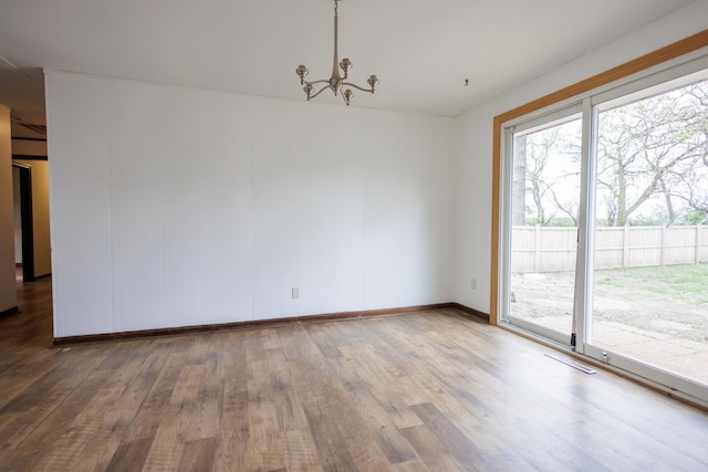 2214 N Bur Oak Ct, Bonfield, IL 60913 - spare room featuring visible vents, baseboards, wood finished floors, and a chandelier