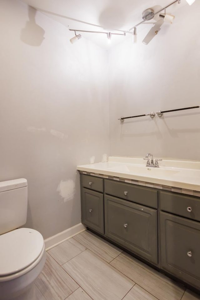 2214 N Bur Oak Ct, Bonfield, IL 60913 - half bathroom featuring vanity, baseboards, and toilet