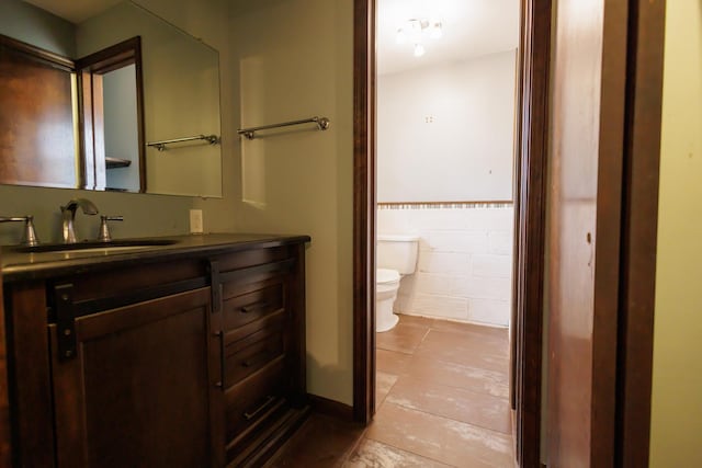 2214 N Bur Oak Ct, Bonfield, IL 60913 - bathroom featuring tile walls, tile patterned flooring, wainscoting, vanity, and toilet