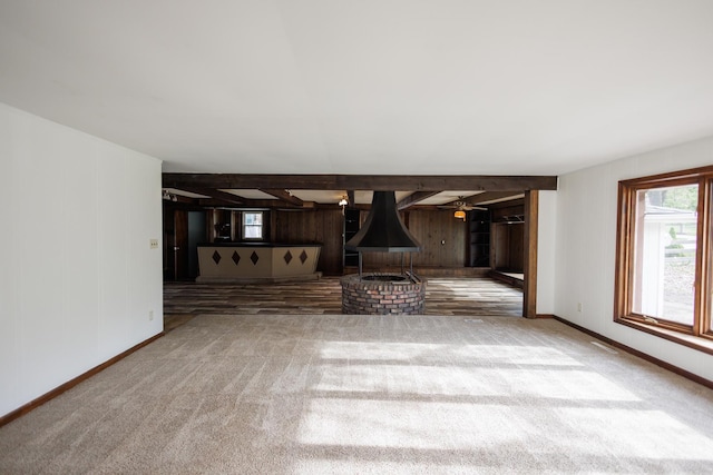 2214 N Bur Oak Ct, Bonfield, IL 60913 - unfurnished living room with baseboards, carpet, wooden walls, and beamed ceiling