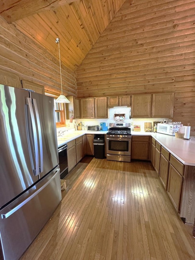 kitchen featuring high vaulted ceiling, light countertops, wooden ceiling, hardwood / wood-style flooring, and appliances with stainless steel finishes