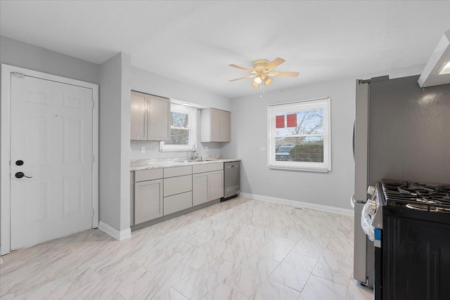 877 163rd St, Calumet City, IL 60409 - kitchen featuring a healthy amount of sunlight, gray cabinets, a ceiling fan, a sink, and stainless steel appliances