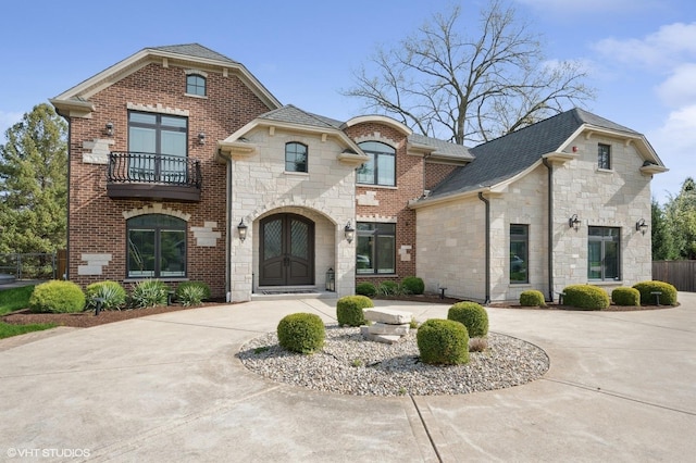 3244 Lakeside Ave, Northbrook, IL 60062 - french country style house featuring curved driveway, a balcony, and stone siding