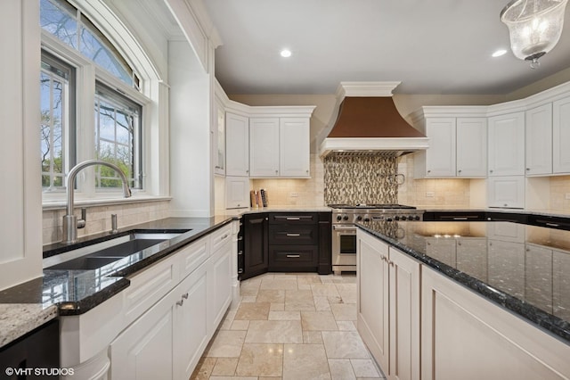 3244 Lakeside Ave, Northbrook, IL 60062 - kitchen with stone tile floors, custom exhaust hood, white cabinetry, a sink, and stainless steel range