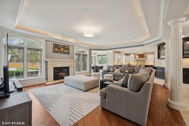 3244 Lakeside Ave, Northbrook, IL 60062 - living area featuring ornamental molding, wood finished floors, ornate columns, a high end fireplace, and a tray ceiling