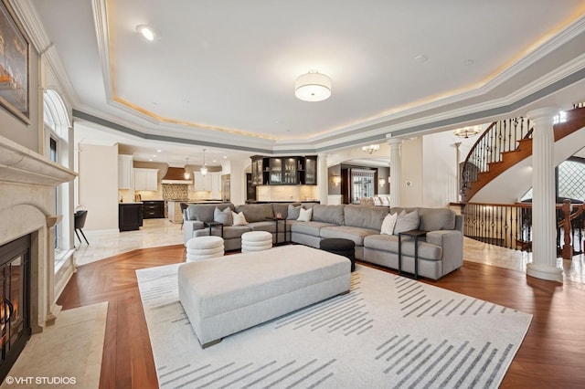 3244 Lakeside Ave, Northbrook, IL 60062 - living room featuring crown molding, stairs, ornate columns, a high end fireplace, and a tray ceiling