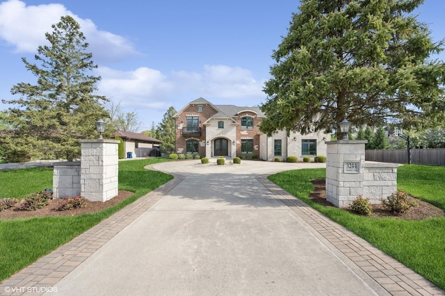 3244 Lakeside Ave, Northbrook, IL 60062 - french country home featuring fence, curved driveway, and a front lawn