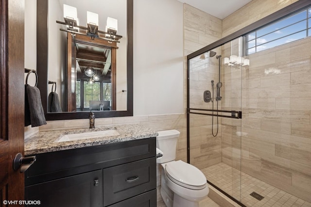 3244 Lakeside Ave, Northbrook, IL 60062 - bathroom featuring wainscoting, vanity, toilet, tile walls, and a stall shower