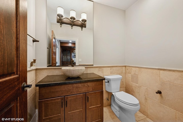 3244 Lakeside Ave, Northbrook, IL 60062 - half bath featuring wainscoting, tile patterned flooring, vanity, toilet, and tile walls