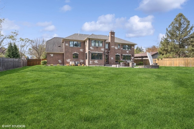 3244 Lakeside Ave, Northbrook, IL 60062 - rear view of property featuring brick siding, a fenced backyard, a yard, and a chimney