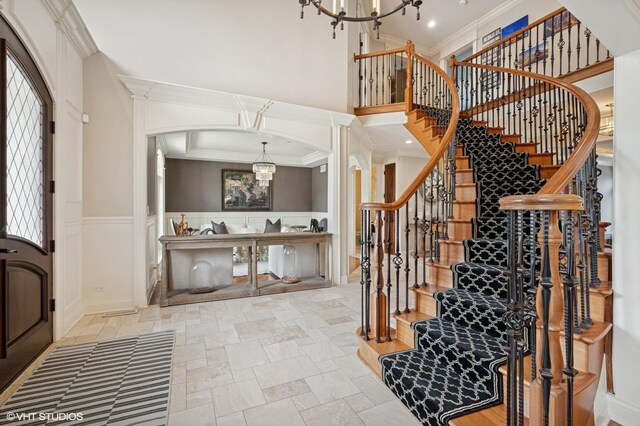 3244 Lakeside Ave, Northbrook, IL 60062 - stairs with stone tile floors, arched walkways, a notable chandelier, and ornamental molding