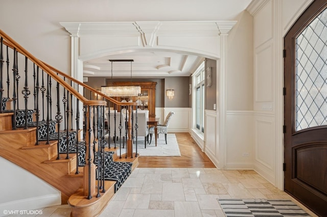 3244 Lakeside Ave, Northbrook, IL 60062 - foyer with arched walkways, plenty of natural light, a notable chandelier, and stone tile floors
