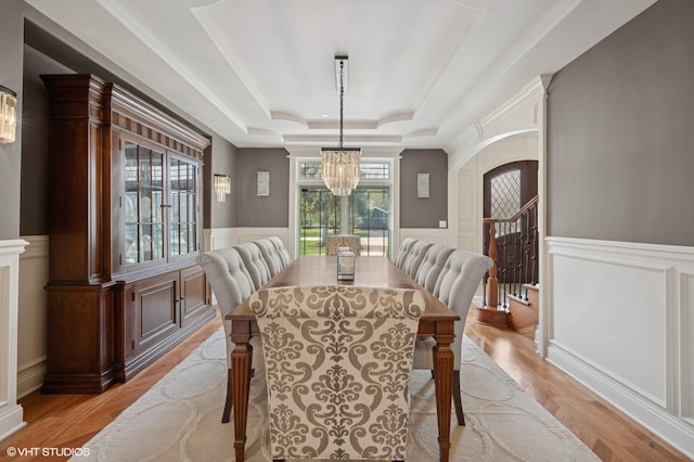3244 Lakeside Ave, Northbrook, IL 60062 - dining space featuring an inviting chandelier, wainscoting, a raised ceiling, a decorative wall, and light wood-style floors