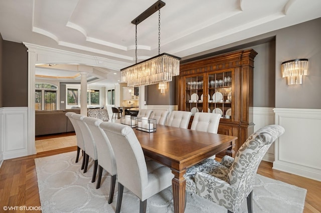 3244 Lakeside Ave, Northbrook, IL 60062 - dining room with a tray ceiling, wainscoting, a chandelier, a decorative wall, and ornate columns