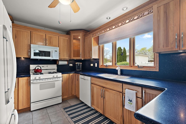 17130 Inverness Dr, Tinley Park, IL 60487 - kitchen featuring light tile patterned flooring, dark countertops, a sink, white appliances, and tasteful backsplash