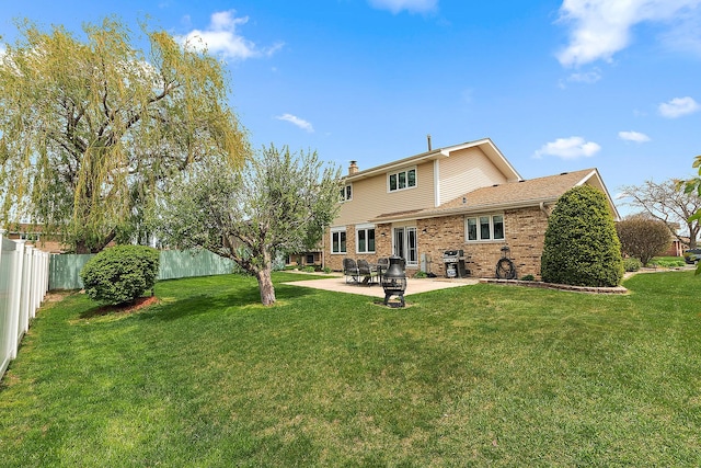 17130 Inverness Dr, Tinley Park, IL 60487 - rear view of house with a fenced backyard, a chimney, brick siding, a patio area, and a lawn