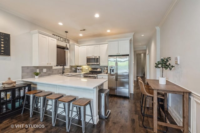 4220 S King Dr Unit 2S, Chicago, IL 60653 - kitchen featuring a sink, appliances with stainless steel finishes, crown molding, and a peninsula