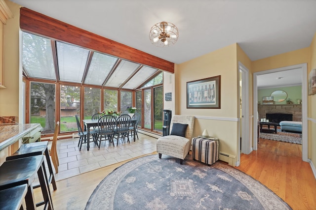 227 Abbott Pl, Tower Lakes, IL 60010 - dining space featuring wood finished floors, a baseboard heating unit, and a fireplace