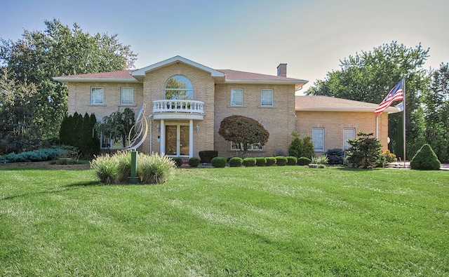 2125 Harrow Gate Dr, Inverness, IL 60010 - georgian-style home with a chimney, a front yard, and a balcony