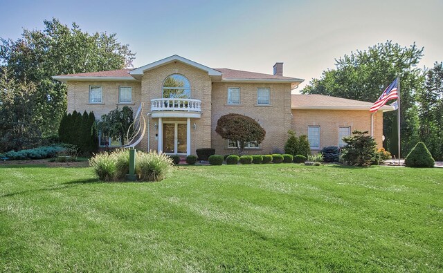 2125 Harrow Gate Dr, Inverness, IL 60010 - georgian-style home featuring a balcony, a front yard, and a chimney