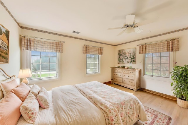2125 Harrow Gate Dr, Inverness, IL 60010 - bedroom featuring baseboards, multiple windows, wood finished floors, and visible vents