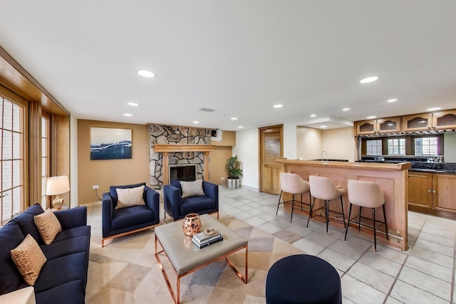 2125 Harrow Gate Dr, Inverness, IL 60010 - living room featuring recessed lighting, a stone fireplace, light tile patterned floors, and baseboards