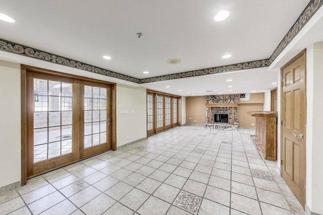 2125 Harrow Gate Dr, Inverness, IL 60010 - unfurnished living room featuring a stone fireplace, recessed lighting, light tile patterned floors, healthy amount of natural light, and baseboards