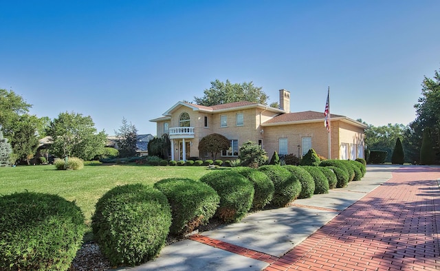 2125 Harrow Gate Dr, Inverness, IL 60010 - view of front of home featuring a chimney, a front yard, and brick siding