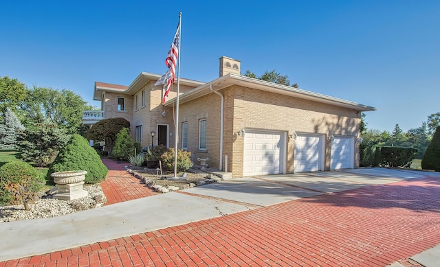 2125 Harrow Gate Dr, Inverness, IL 60010 - view of front facade with a chimney, brick siding, and driveway