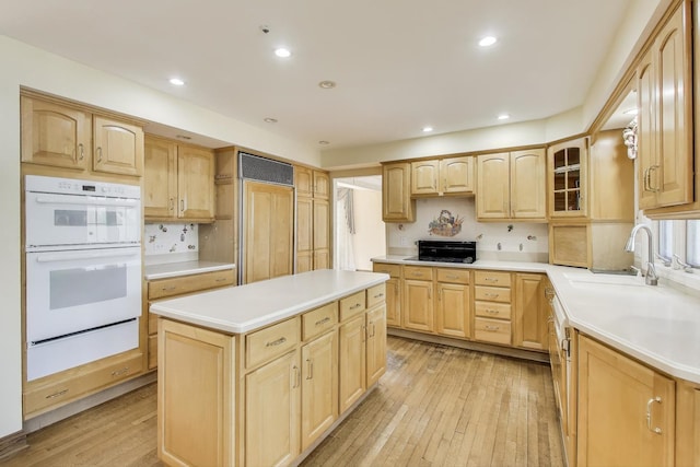 2125 Harrow Gate Dr, Inverness, IL 60010 - kitchen with light brown cabinetry, double oven, a warming drawer, light wood-type flooring, and a sink
