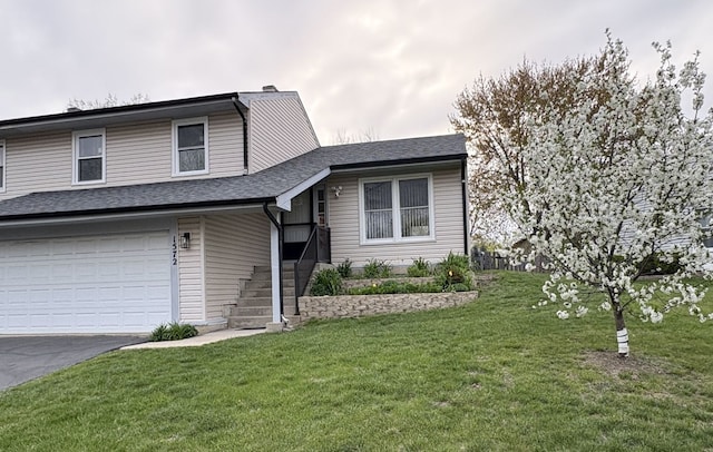 1572 Brandywyn Ln, Buffalo Grove, IL 60089 - tri-level home with a shingled roof, an attached garage, a front lawn, a chimney, and driveway