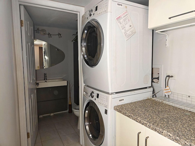 1572 Brandywyn Ln, Buffalo Grove, IL 60089 - clothes washing area with tile patterned flooring, a sink, cabinet space, and stacked washing maching and dryer