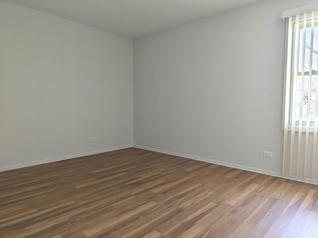 1572 Brandywyn Ln, Buffalo Grove, IL 60089 - spare room with baseboards and dark wood-type flooring
