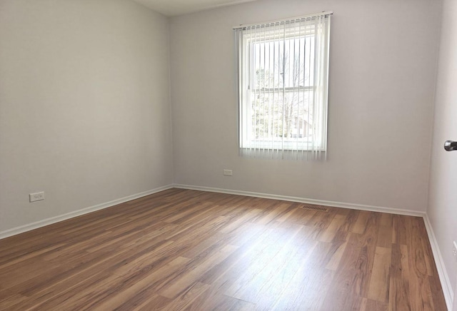 1572 Brandywyn Ln, Buffalo Grove, IL 60089 - unfurnished room featuring baseboards, visible vents, and wood finished floors