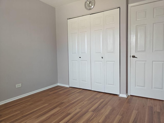 1572 Brandywyn Ln, Buffalo Grove, IL 60089 - unfurnished bedroom featuring a closet, dark wood finished floors, and baseboards