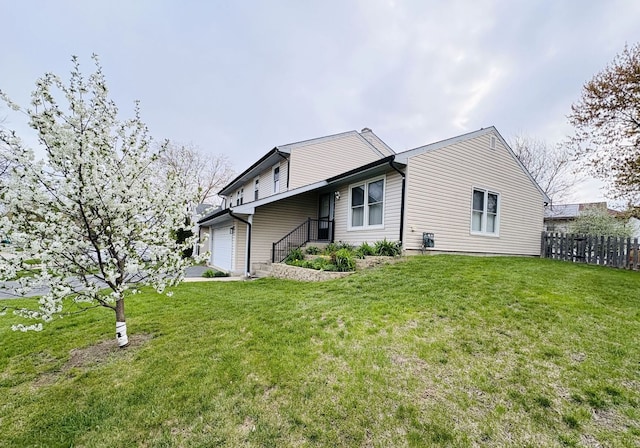 1572 Brandywyn Ln, Buffalo Grove, IL 60089 - rear view of house with a garage, fence, and a lawn