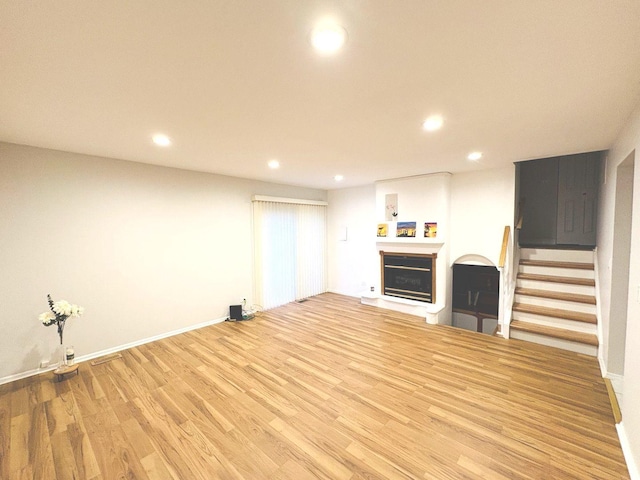 1572 Brandywyn Ln, Buffalo Grove, IL 60089 - unfurnished living room featuring a fireplace, baseboards, stairway, recessed lighting, and light wood finished floors