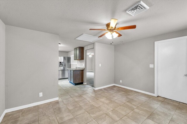 902 N Lincoln Ave, Urbana, IL 61801 - unfurnished living room with ceiling fan, baseboards, and a textured ceiling