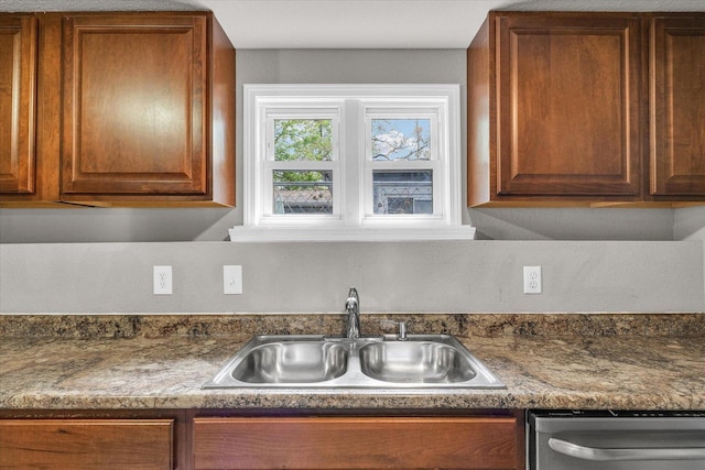 902 N Lincoln Ave, Urbana, IL 61801 - kitchen with a sink, stainless steel dishwasher, dark countertops, and brown cabinets