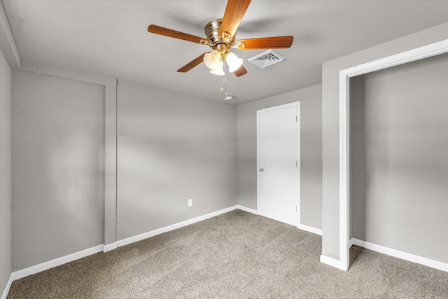 902 N Lincoln Ave, Urbana, IL 61801 - unfurnished bedroom with carpet flooring, baseboards, and a ceiling fan