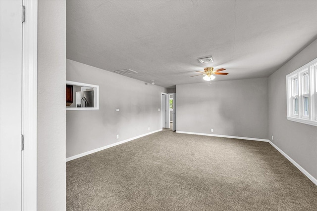 902 N Lincoln Ave, Urbana, IL 61801 - carpeted spare room with ceiling fan, baseboards, healthy amount of natural light, and a textured ceiling