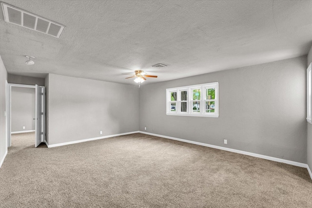 902 N Lincoln Ave, Urbana, IL 61801 - carpeted spare room featuring ceiling fan, baseboards, and a textured ceiling