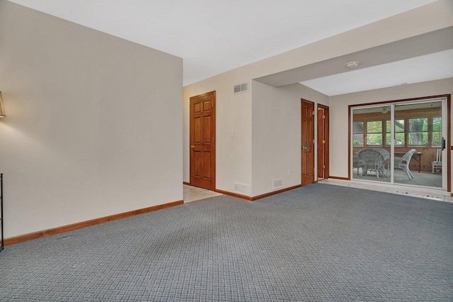 empty room with baseboards, carpet flooring, and visible vents