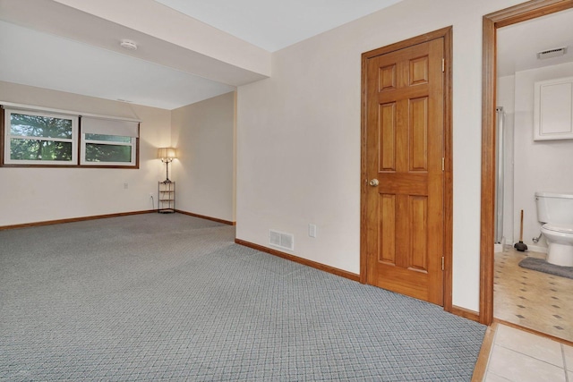 unfurnished room with baseboards, light carpet, and visible vents