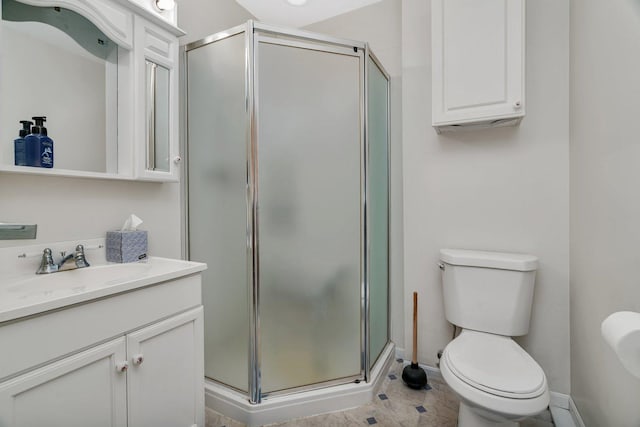 full bath featuring baseboards, a stall shower, toilet, and vanity