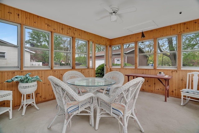 sunroom / solarium featuring a ceiling fan and outdoor dining area