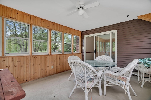 sunroom with plenty of natural light, outdoor dining space, and ceiling fan