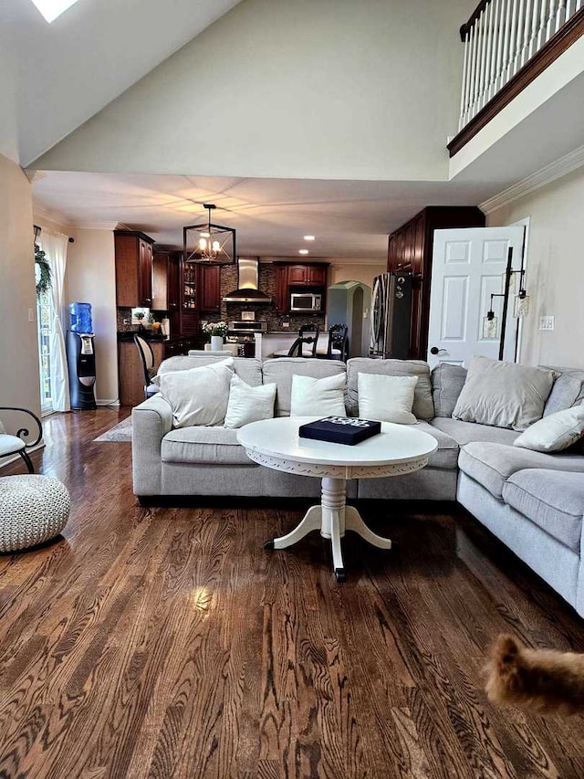 80 Chestnut Ct, Elgin, IL 60120 - living area with high vaulted ceiling, dark wood-style floors, arched walkways, and ornamental molding